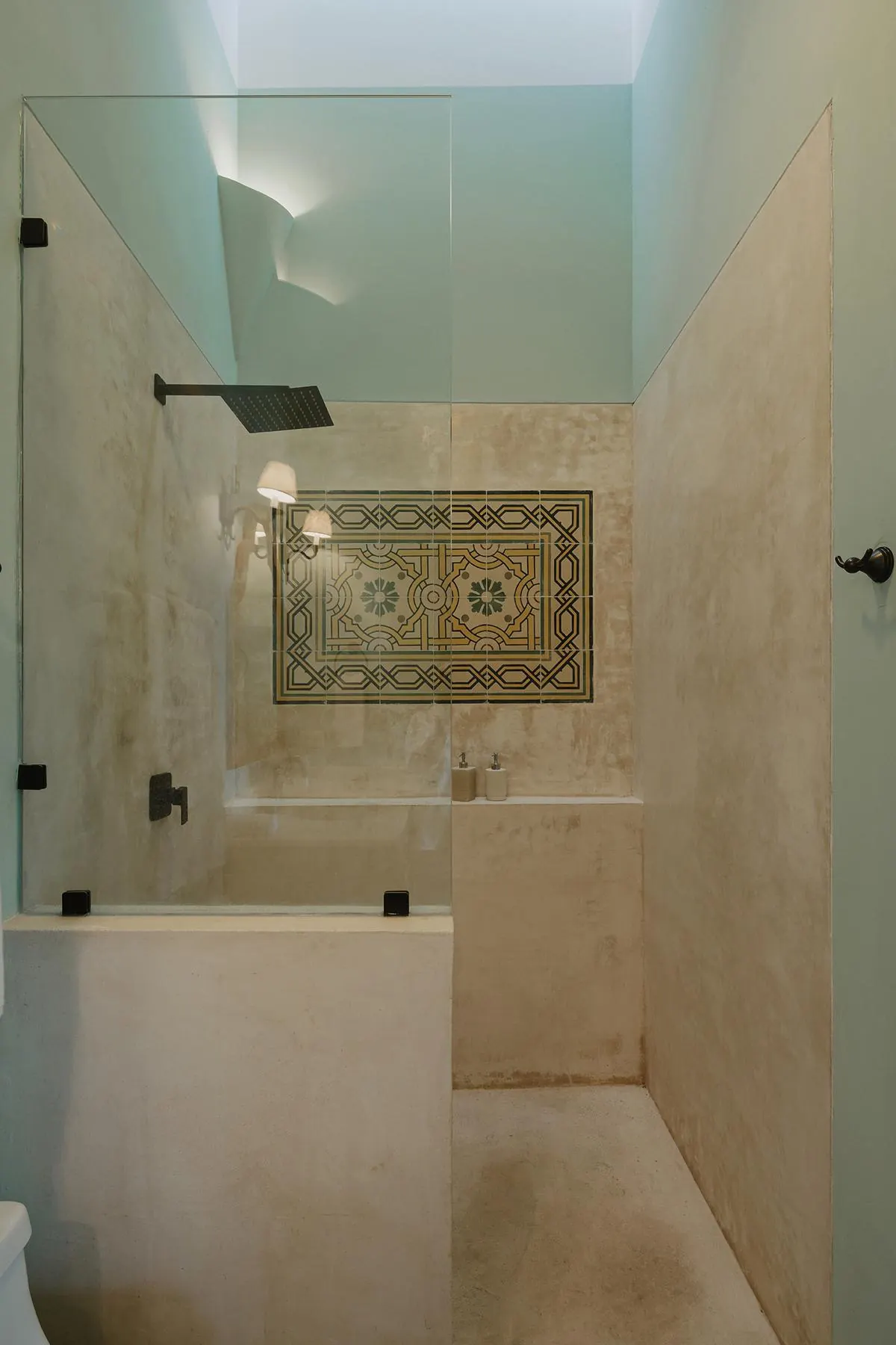 Bathroom with plaster walls and a cement-tile panel