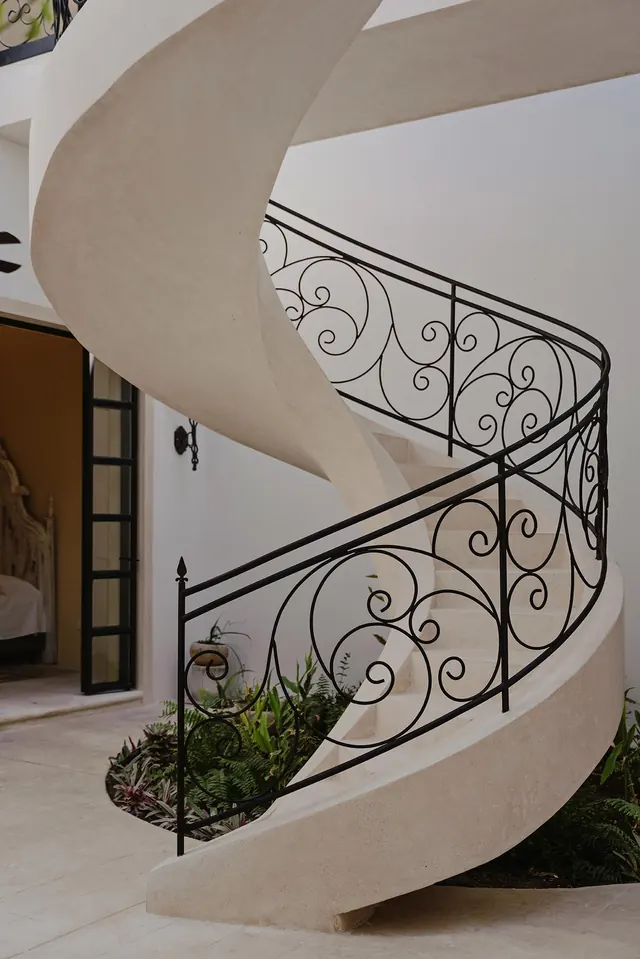 Self-supporting spiral stair with scrolled iron railing