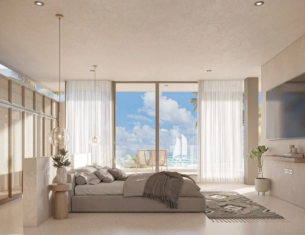 Main bedroom facing the sea through full-height glass