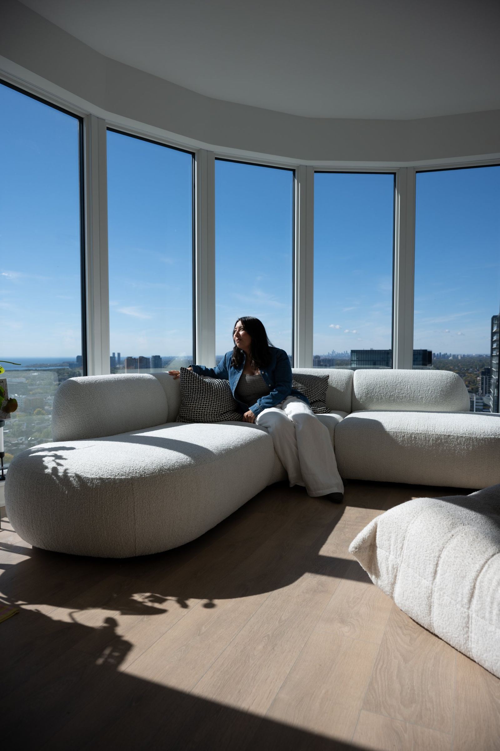 Jessica Park looking out over Toronto from a room of curved windows