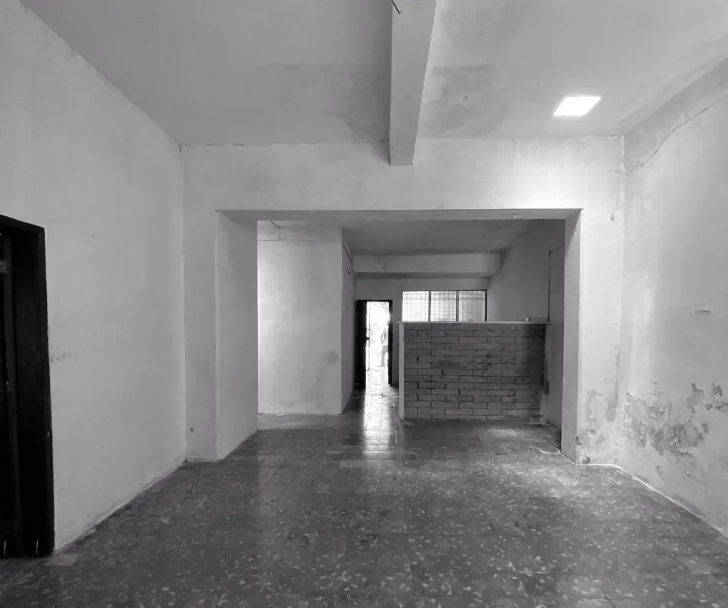 Living area before renovation, looking toward the back of the house